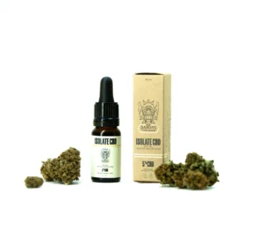 Photo du flacon d'huile et de son paquet en carton entourés de fleurs de CBD